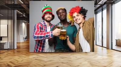 Holidays leisure funtime football soccer fan concept. Friendly three mixed race excited cheerful guys making selfie fans support isolated on white background Wall mural